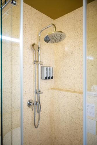 a shower with a shower head in a bathroom at Ciccio Rooms and breakfast - Self check-in in Palermo