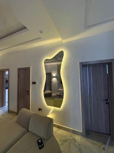 a living room with a couch and a mirror at 2bedroom luxury apartment in Lekki