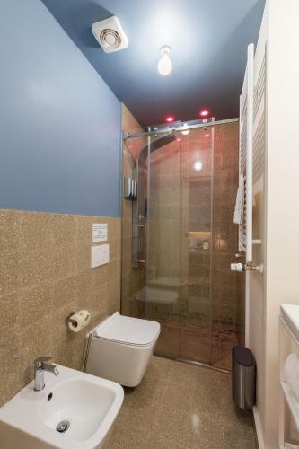 a bathroom with a shower and a toilet and a sink at Ciccio Rooms and breakfast - Self check-in in Palermo