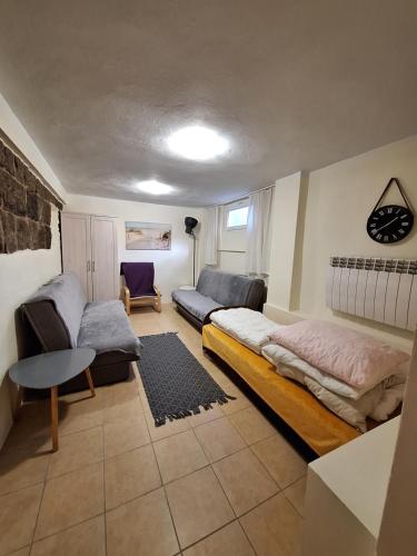 a living room with a bed and a couch at To Tu in Ruciane-Nida