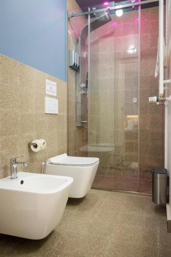 a bathroom with a toilet and a sink and a shower at Ciccio Rooms and breakfast - Self check-in in Palermo