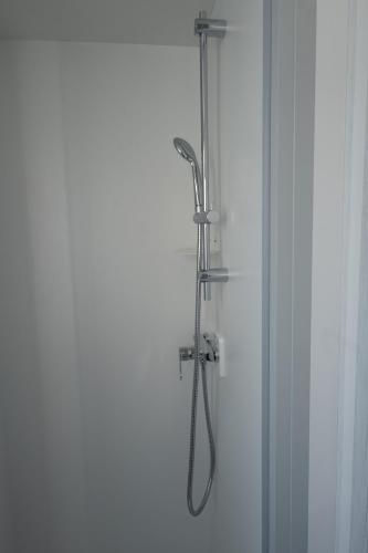 a shower in a bathroom with a glass door at Bungalow Safari 2 in Tarifa
