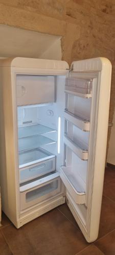 an empty refrigerator with its door open in a room at Domus Hispellum in Spello