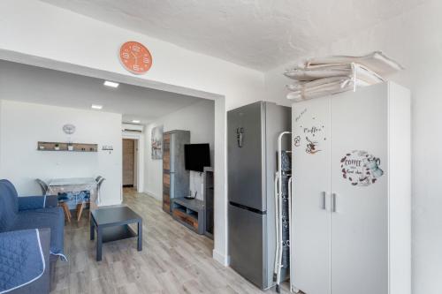 a living room with a refrigerator and a table at Daniel House in Mogán