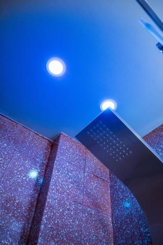 a building with purple lights and a blue sky at Ciccio Rooms and breakfast - Self check-in in Palermo