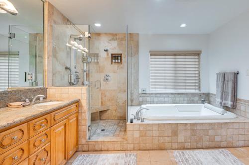 a bathroom with a tub and a shower and a sink at 8 Mi to Dtwn Home with Fireplace and Games in LA! in Los Angeles