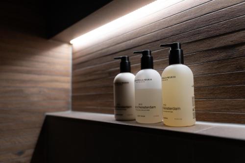 a group of three bottles sitting on a shelf at Bed & breakfast De Loeghoeve in Anderen