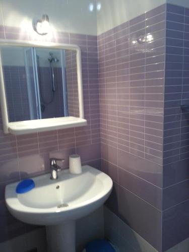 a bathroom with a sink and a mirror at Casa Mazzini Yellow in Favignana