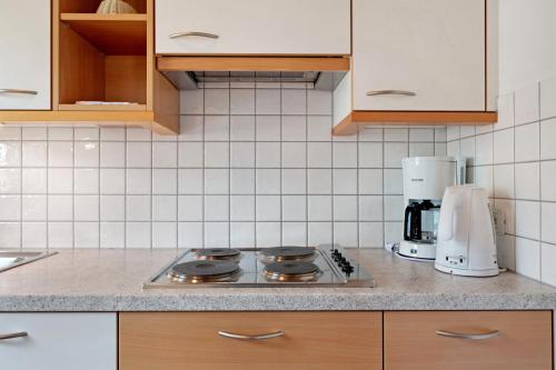 a kitchen counter with a stove and a coffee maker at Hofanger in Lagundo
