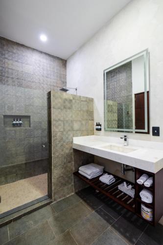 a bathroom with a sink and a shower at Hotel Miranda Querétaro in Querétaro
