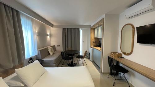 a hotel room with a bed and a table at Alexia Beach Hotel in Agia Marina Nea Kydonias