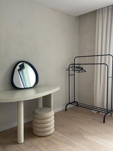 a room with a table with a mirror and a shelf at Casa L in Ulcinj
