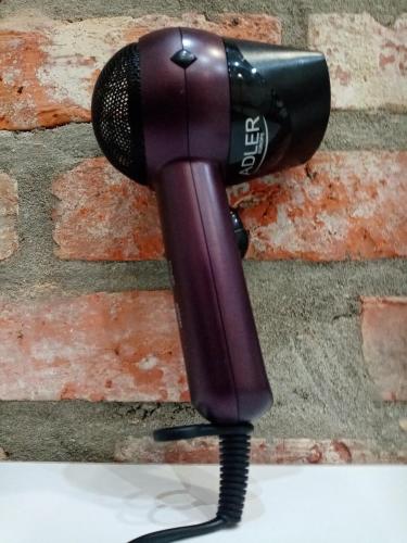 a hair dryer is attached to a brick wall at Sava & Double Rooms in Prijedor