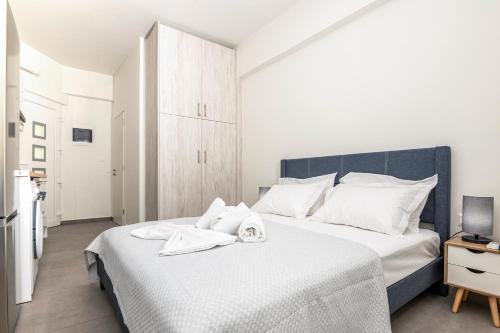 a bedroom with a bed with towels on it at Demar Studios in Lefkogeia