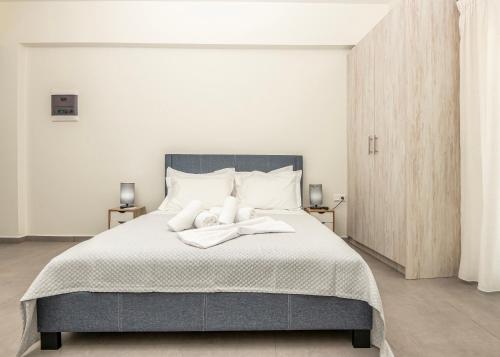 a bedroom with a large bed with two towels on it at Demar Studios in Lefkogeia