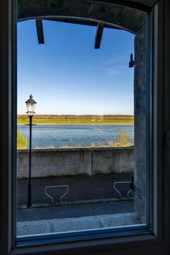 a window with a view of a body of water at Holiday Home Janssen & Janssen in Maasmechelen