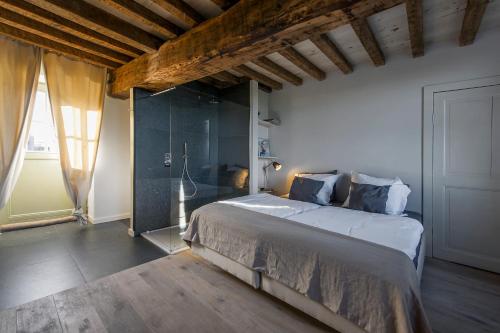 a bedroom with a large bed and a glass wall at Holiday Home Janssen & Janssen in Maasmechelen