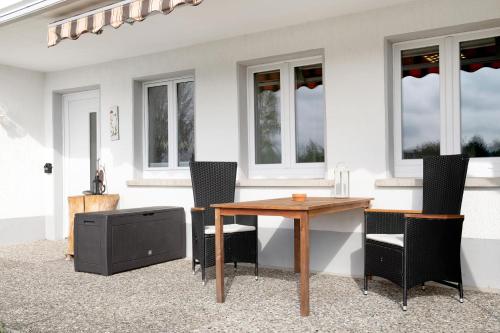 a table with chairs and a television in a patio at Ferienwohnung im Haus Böll in Feldberg
