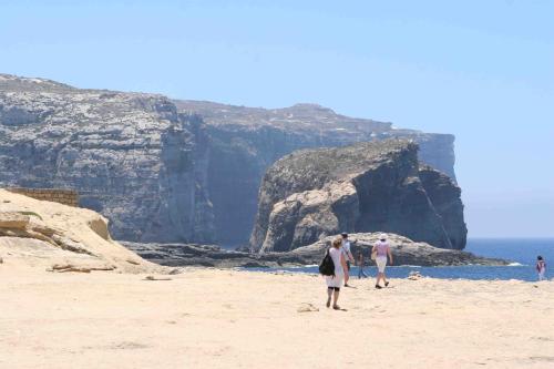 a group of people standing on a beach at B3 Misrah Ta Cenc in Sannat