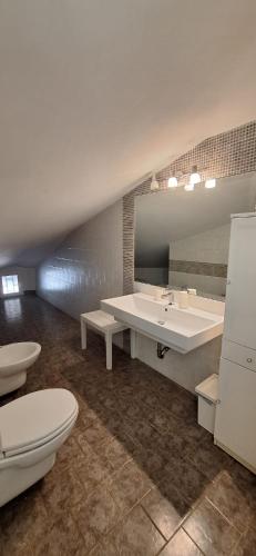 a bathroom with a white sink and a toilet at Villa Sara B&B in Civitavecchia