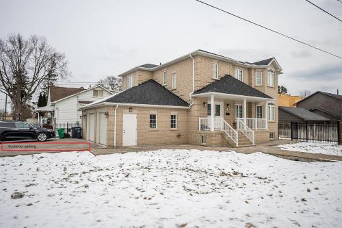 a house with snow on the ground in front of it at Tranquil 2bedroom basement in charming Mississauga in Mississauga