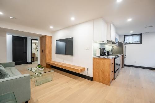 a large living room with a couch and a kitchen at Tranquil 2bedroom basement in charming Mississauga in Mississauga