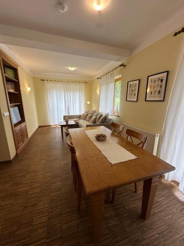 a living room with a table and a couch at Apartments Vršič on the ski slope with free parking in Kranjska Gora