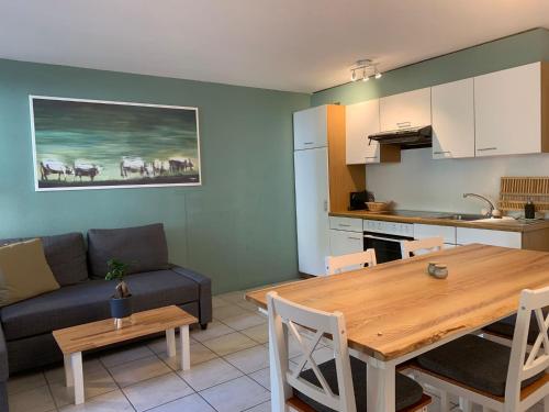 a kitchen and a living room with a table and a couch at Casa Gialla in Russo