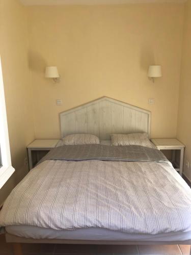 - un lit dans une chambre avec 2 tables de nuit dans l'établissement Le Dramont, sea view, pool, 4-5 people, air conditioning , Wi-Fi, à Saint-Raphaël