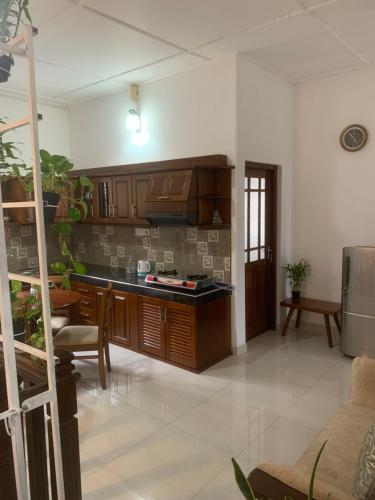 a kitchen with wooden cabinets and a table in a room at Captain's Ridge in Nattarampota