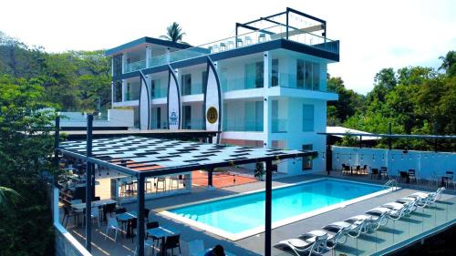 a house with a swimming pool next to a building at The Views Resort in El Zonte