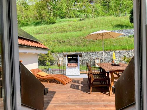 a patio with a table and an umbrella at Casa Gialla in Russo