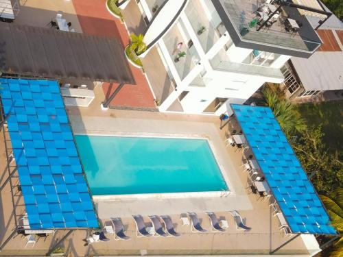 an overhead view of a swimming pool with lounge chairs at The Views Resort in El Zonte