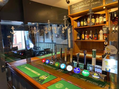 a bar with lots of bottles of alcohol at Sanctuary Rooms in Brightlingsea