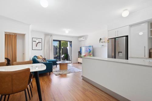 a kitchen and living room with a table and chairs at Comfort & Convenience A Sepal Stay in Perth