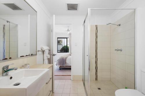 a white bathroom with a sink and a shower at Comfort & Convenience - A Sepal Stay in Perth
