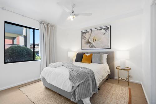 a white bedroom with a bed and a window at Comfort & Convenience - A Sepal Stay in Perth