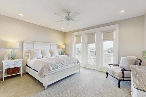 a bedroom with a white bed and a chair at No Time to Worry in Rockport