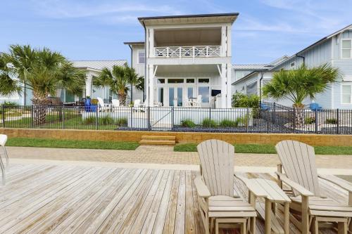 a house with two chairs and a porch at No Time to Worry in Rockport