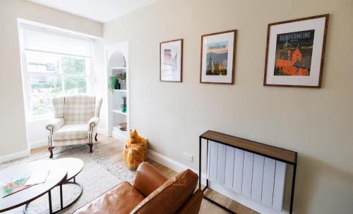 a living room with a couch and a chair at Stylish 2-Bed Apartment in the Heritage Quarter in Dunfermline