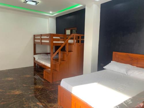 a bedroom with two bunk beds and a staircase at Pinlac Private Resort in San Fabian