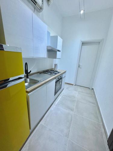 a kitchen with white cabinets and a stove top oven at ApartHotel Verona Centro in Verona