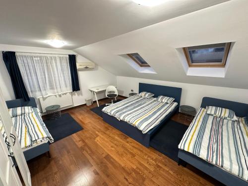 a bedroom with two beds in a room at Emun Grigo Lofthouse in Cluj-Napoca