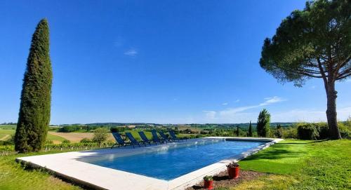 - une piscine avec des chaises et un arbre dans l'établissement Maison Gasconne, 6 chambres, piscine 14x5, vue sur les vignobles, à Castelnau-sur-lʼAuvignon