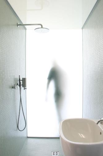 a white bathroom with a sink and a shower at Landloft in Sausal