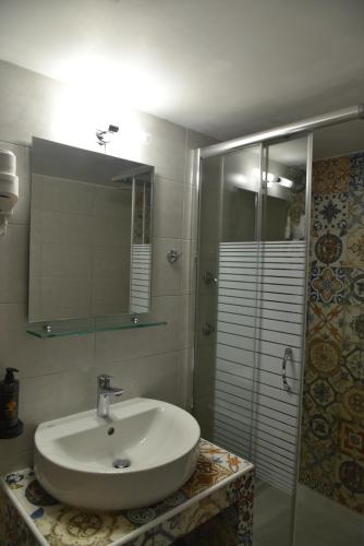 a bathroom with a sink and a shower at Pension 2Be in Nafplio