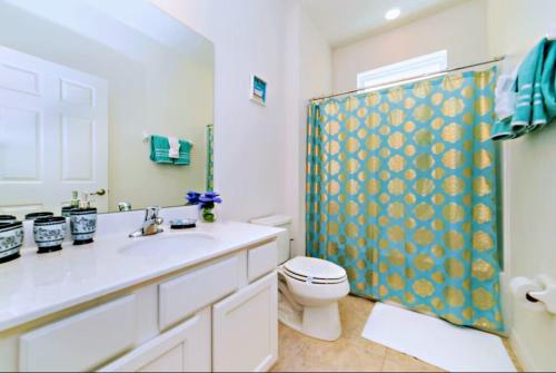a bathroom with a sink and a toilet and a shower at Spacious King, Queen Rooms in Luxury Villa-Pool-SPA-Disney-WiFi-Smart TV in Davenport