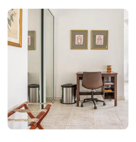 an office with a desk and a chair and a table at Casa Sofia in Guaynabo