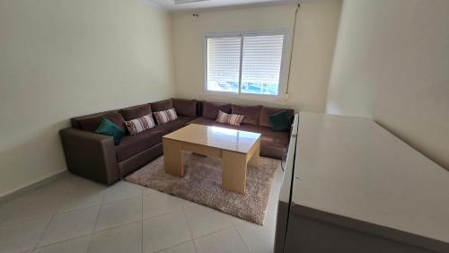 a living room with a couch and a coffee table at appartement 2 chambres et salon confort in Gzennaïa