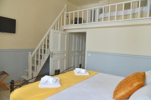 a bedroom with a bed with two towels on it at Pension 2Be in Nafplio